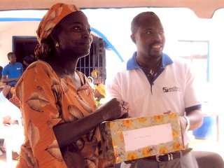A director, James Oritse, presenting an award to a loyal customer recently.jpg